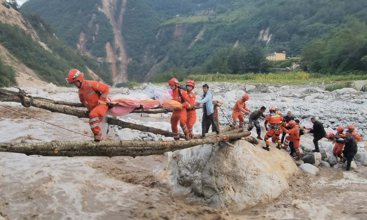Sichuan branch of armed forces transfer stranded people in a village of Luding county, Sichuan, after a 6.8-magnitude earthquake struck Luding on Monday. The earthquake has claimed 46 lives as of Monday night, media reported. Photo: Xinhua 