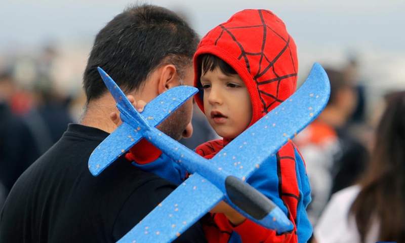 A child holds an airplane toy during Bucharest International Air Show & General Aviation Exhibition in Bucharest, Romania, on Sept. 4, 2022.Photo:Xinhua