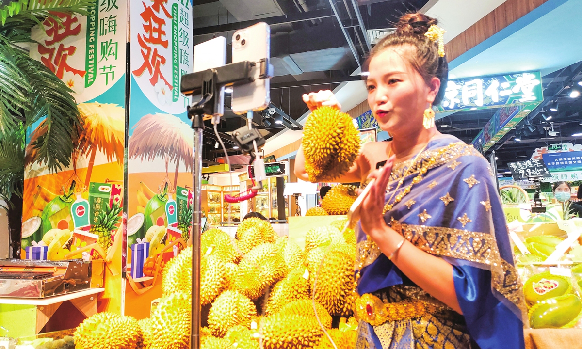 Sales staff shows durian imported from Thailand. Photo: VCG
