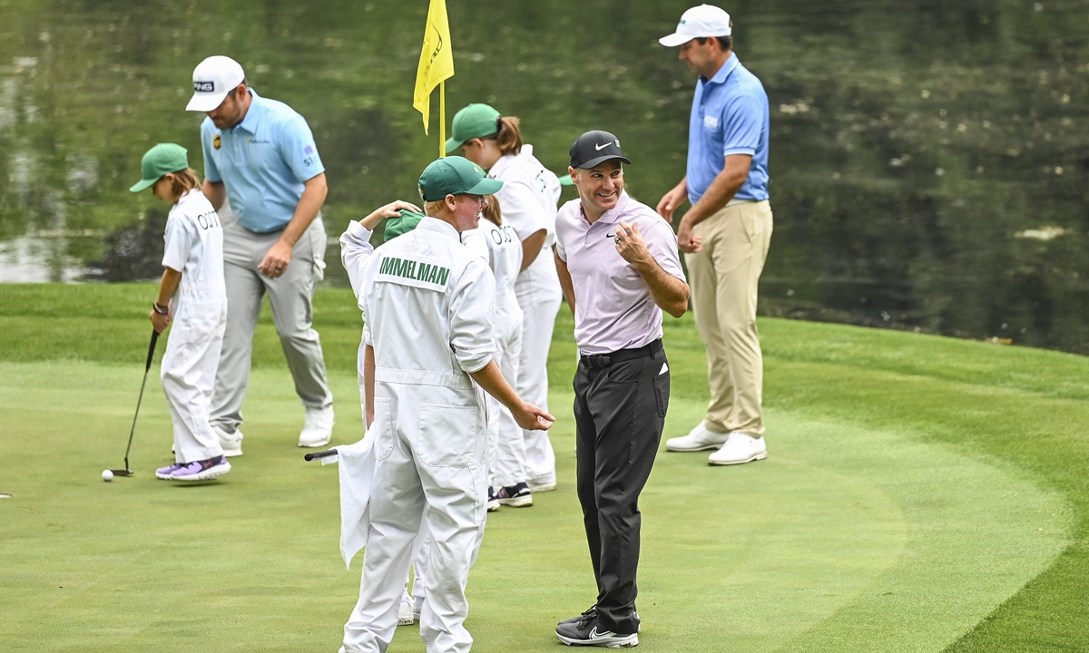Trevor Immelman (center) of South Africa smiles during the Par Three Contest prior to the Masters at Augusta National Golf Club in Augusta, the US on April 6, 2022. Photo: AFP