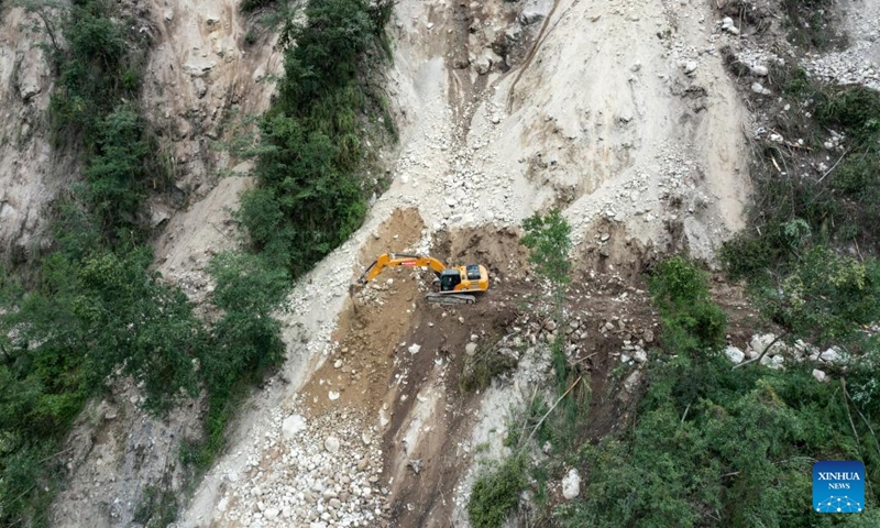 Aerial photo shows rescue workers fixing a road linking to Hailuogou scenic area around Moxi Town of Luding County, southwest China's Sichuan Province, Sept. 7, 2022.(Photo: Xinhua)