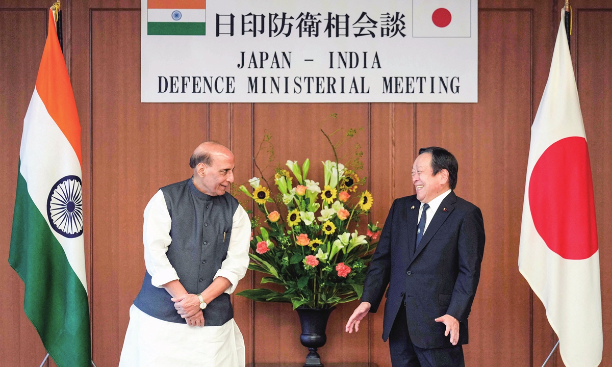 India's Defence Minister Rajnath Singh (left) and Japan's Defence Minister Yasukazu Hamada pose for photos before the second Japan-India 