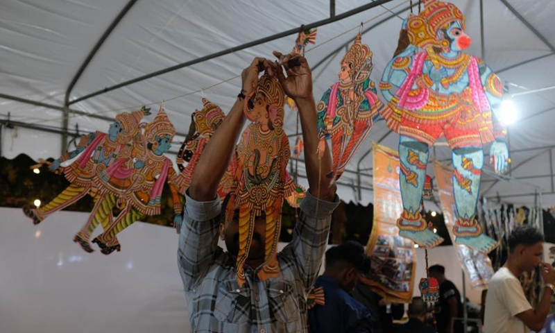 An exhibitor puts his shadow puppet works in place during a shadow puppet show in Phetchaburi Province, Thailand, Sept. 10, 2022.Photo:Xinhua