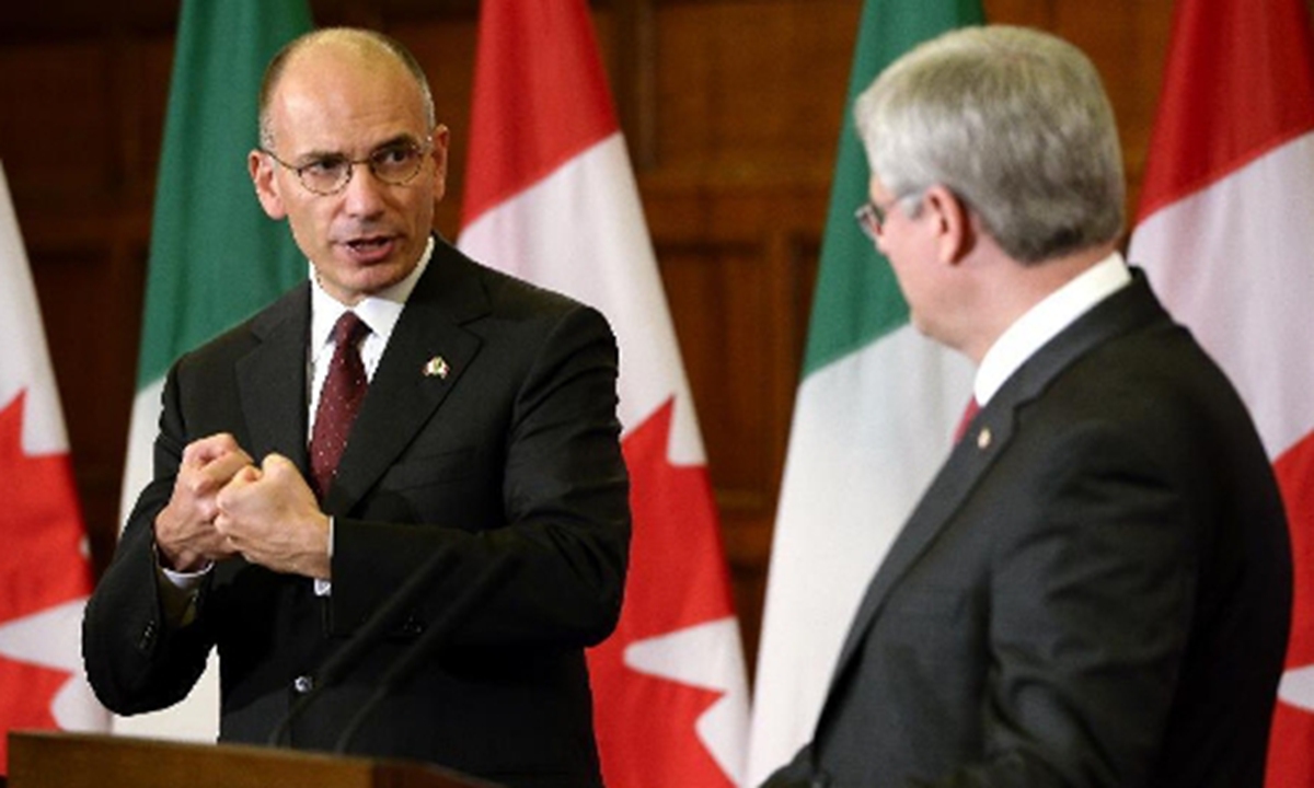 Italian Prime Minister Enrico Letta (L) gestures to Canada's Prime Minister Stephen Harper during a joint press conference at Parliament Hill in Ottawa, Canada, Sept. 23, 2013. Italian Prime Minister Enrico Letta's first official visit to Canada since taking office earlier this year focused on bilateral trade and investment. But a joint news conference here Monday involving Letta and his host, Canadian Prime Minister Stephen Harper, was highlighted by security concerns. (Xinhua/James Park)