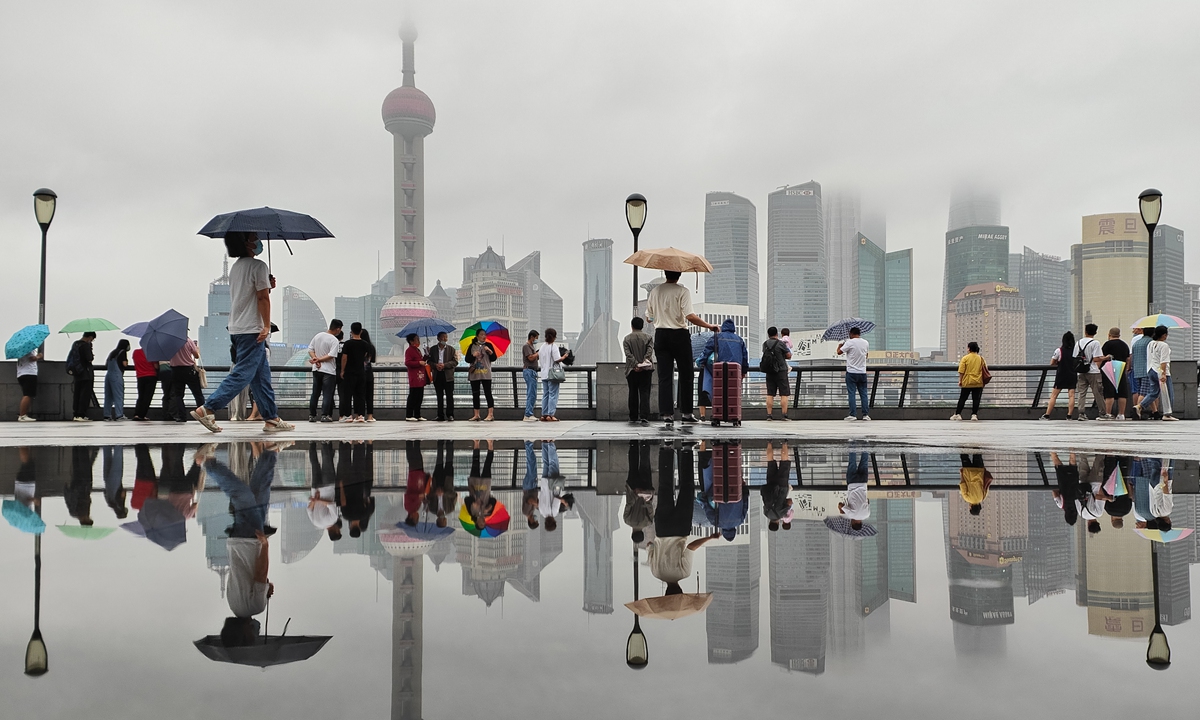 Tourists visit the Bund in Shanghai as rain falls during the afternoon on September 13, 2022. Heavy rain is expected to hit Shanghai as Typhoon Muifa storms toward the city. Photo: IC