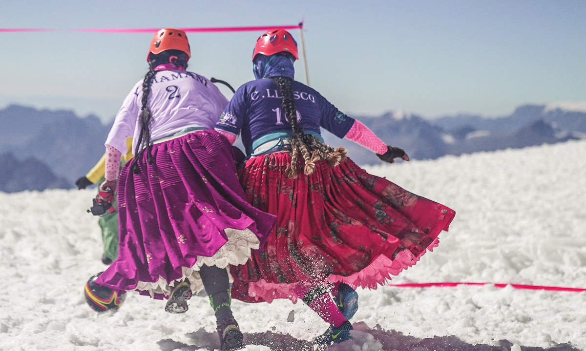 Members of the Climbing Cholitas of Bolivia Warmis play soccer on Huayna Potosi in Bolivia. Photo: AFP