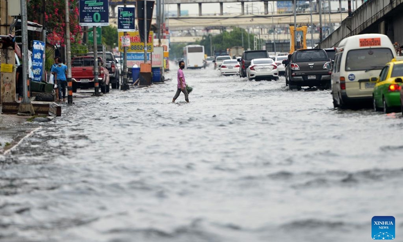 A man wades through floodwater in Bangkok, Thailand, on Sept. 13, 2022. The Bangkok Metropolitan Administration (BMA) on Tuesday issued a warning of moderate to heavy rain and potential floods from 4 p.m. to 11 p.m local time in the Thai capital's 12 districts. This came after several parts of the city had been inundated after heavy monsoon rains in the last several days.(Photo: Xinhua)