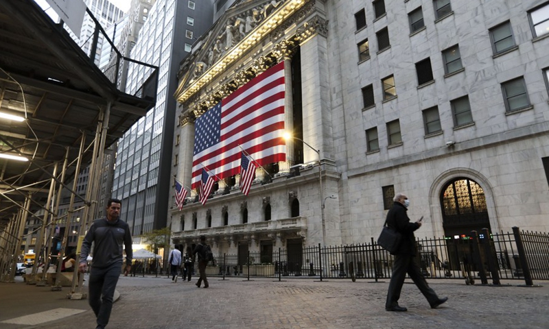 Pedestrians walk past the New York Stock Exchange in New York, the United States. File Photo:Xinhua