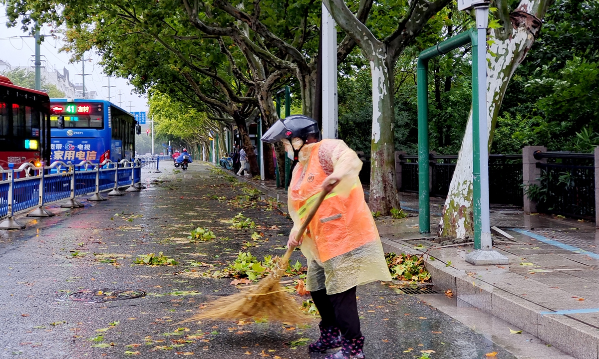 A sanitation worker clears fallen leaves on a street in Nantong city, East China's Jiangsu Province, hit by Typhoon Muifa on September 15, 2022. Photo: IC