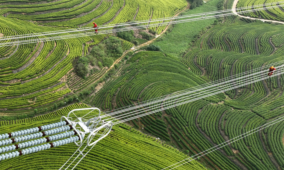 Workers carry out an inspection of the Baihetan-Zhejiang 800-kilovolt ultra-high voltage direct current transmission line project in Huzhou, East China's Zhejiang Province, on September 18, 2022. The line will transfer 23.6 billion kilowatt-hours of hydropower to Zhejiang every year. Photo: VCG