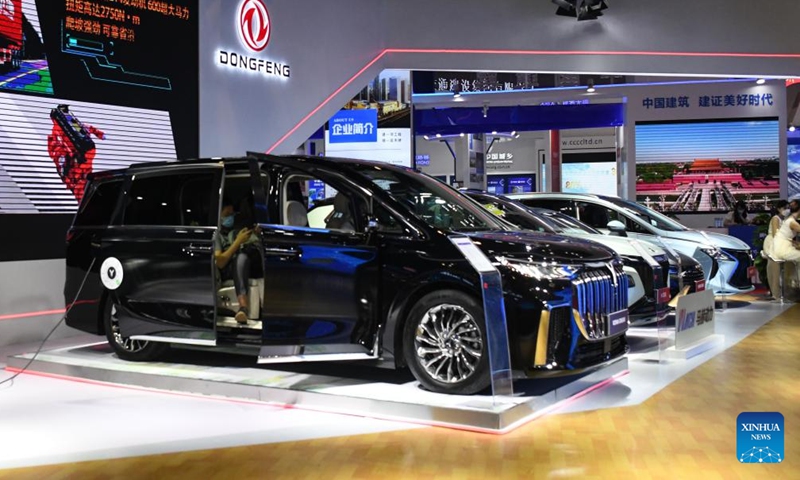 A visitor tries a new energy car during the 19th China-ASEAN Expo in Nanning, capital of south China's Guangxi Zhuang Autonomous Region, Sept. 17, 2022.Photo:Xinhua