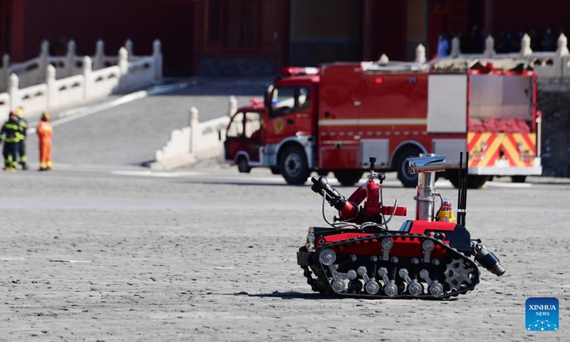 A fire fighting robot is seen during the fire drill held in the Palace Museum, also known as the Forbidden City, in Beijing, capital of China, Sept. 19, 2022. The drill was held to test and enhance fire prevention and emergency response capabilities at the ancient architectural complex.(Photo: Xinhua)