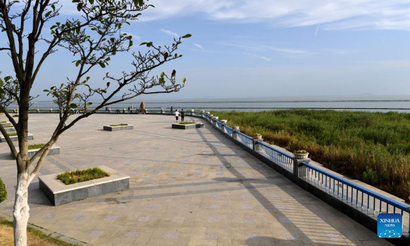 People enjoy themselves in a park at the bank of the Chaohu Lake in Hefei City, east China's Anhui Province, Sept. 6, 2022. As the fifth-largest freshwater lake in China, Chaohu Lake is known as the 