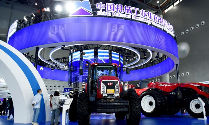 People look at tractors at the 2022 World Manufacturing Convention in Hefei, east China's Anhui Province, Sept. 20, 2022. The 2022 World Manufacturing Convention opened Tuesday in east China, highlighting the latest products, technologies and applications in the manufacturing sector.(Photo: Xinhua)