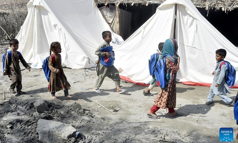 Flood-affected children leave after attending a class at a makeshift school in Charsadda, Pakistan, on Sept. 21, 2022. The total death toll in Pakistan from this season's monsoon rains and floods since mid-June has risen to around 1,569, along with 12,860 injured, the National Disaster Management Authority (NDMA) said.(Photo: Xinhua)