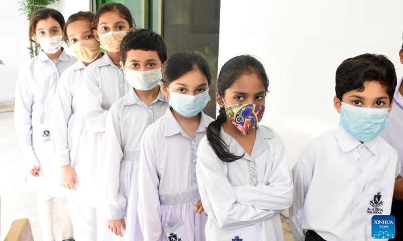 Students wait in queue to receive a dose of COVID-19 vaccine at a school in Lahore, Pakistan, Sept. 20, 2022. Pakistan launched a COVID-19 vaccination campaign on Monday for children aged five to eleven in order to inoculate a maximum number of individuals to control the spread of the disease, the country's health ministry said.(Photo: Xinhua)