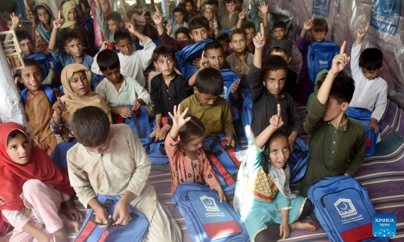 Flood-affected children leave after attending a class at a makeshift school in Charsadda, Pakistan, on Sept. 21, 2022. The total death toll in Pakistan from this season's monsoon rains and floods since mid-June has risen to around 1,569, along with 12,860 injured, the National Disaster Management Authority (NDMA) said.(Photo: Xinhua)