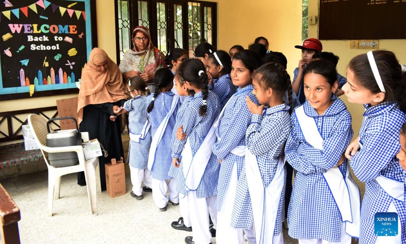 Students wait in queue to receive a dose of COVID-19 vaccine at a school in Lahore, Pakistan, Sept. 20, 2022. Pakistan launched a COVID-19 vaccination campaign on Monday for children aged five to eleven in order to inoculate a maximum number of individuals to control the spread of the disease, the country's health ministry said.(Photo: Xinhua)