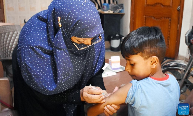 A boy receives a dose of COVID-19 vaccine in Lahore, Pakistan, Sept. 20, 2022. Pakistan launched a COVID-19 vaccination campaign on Monday for children aged five to eleven in order to inoculate a maximum number of individuals to control the spread of the disease, the country's health ministry said.(Photo: Xinhua)