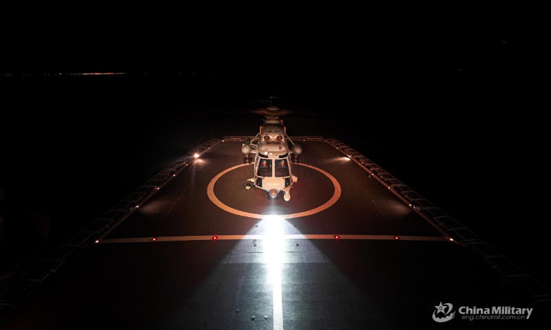 A ship-borne helicopter lands on the helipad of a warship during a round-the-clock training exercise on landing and taking off from the ship's helipad on September 7, 2022. (eng.chinamil.com.cn/Photo by Ma Yingming)