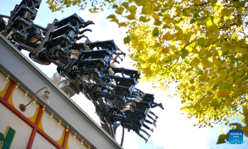 People take a roller coaster at an amusement park in Stockholm, Sweden, Oct. 8, 2022. (Xinhua/Ren Pengfei)
