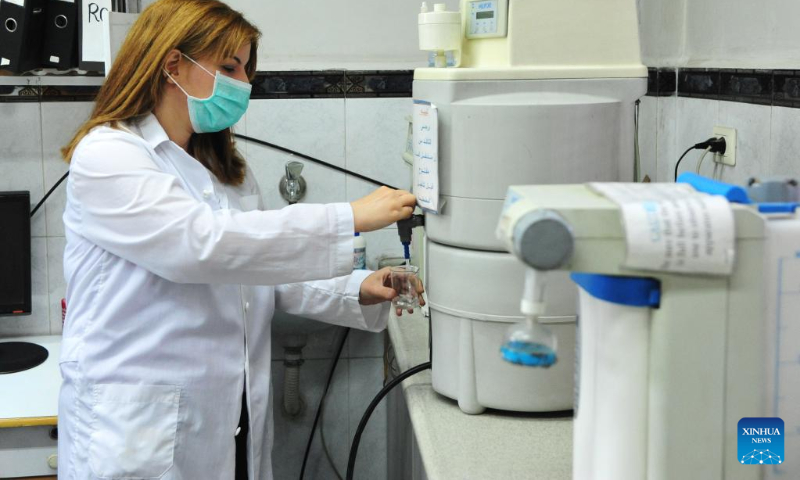 A staff member of Syrian health authority runs tests on water samples collected from different parts of capital Damascus, Syria, Sept. 25, 2022. (Photo by Ammar Safarjalani/Xinhua)
