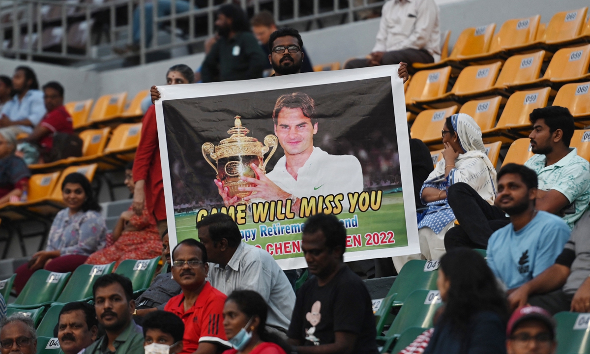 A man holds a placard with a picture of Swiss tennis player Roger Federer in Chennai, India on September 16, 2022, after Federer announced he will retire after the next Laver Cup. Photo: AFP