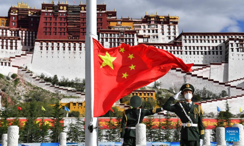 A flag-raising ceremony is held to celebrate the 73rd anniversary of the founding of the People's Republic of China at the Potala Palace square in Lhasa, capital of southwest China's Tibet Autonomous Region, Oct. 1, 2022. (Xinhua/Chogo)