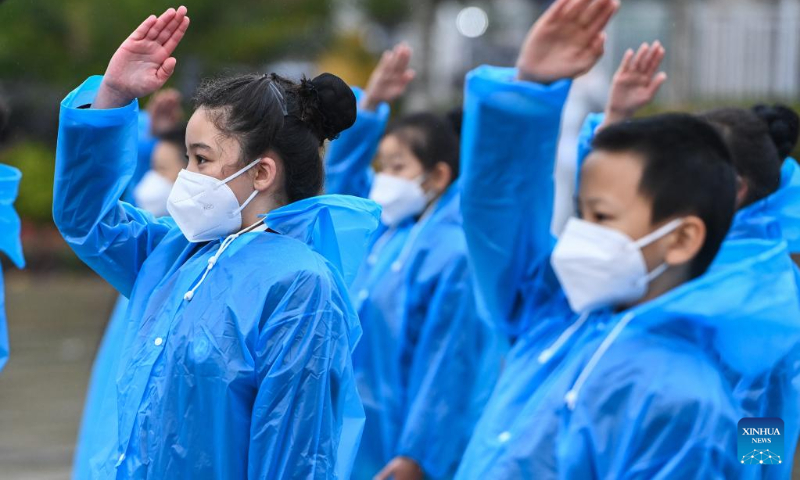 Students pay a tribute to martyrs during a commemorative event at the People's Square in Urumqi, northwest China's Xinjiang Uygur Autonomous Region, Sept. 30, 2022. (Xinhua/Ding Lei)