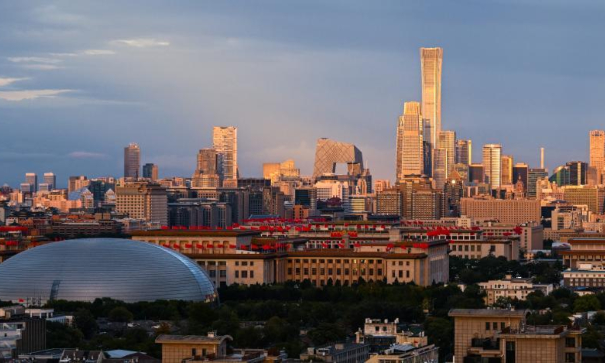 Photo taken on Oct. 3, 2022 shows the view of skyscrapers of the Central Business District (CBD) at dusk in Beijing, capital of China. A cold wave has brought temperature drops and gales to the city, and the temperature on Monday night is expected to plunge to 8 degrees Celsius. (Xinhua/Wang Jianhua)