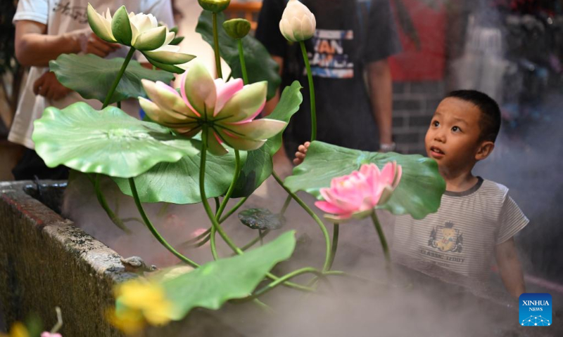 A kid visits Sanfangqixiang (Three Lanes and Seven Alleys), an ancient block, in Fuzhou, southeast China's Fujian Province, Oct. 6, 2022. (Xinhua/Zhou Yi)