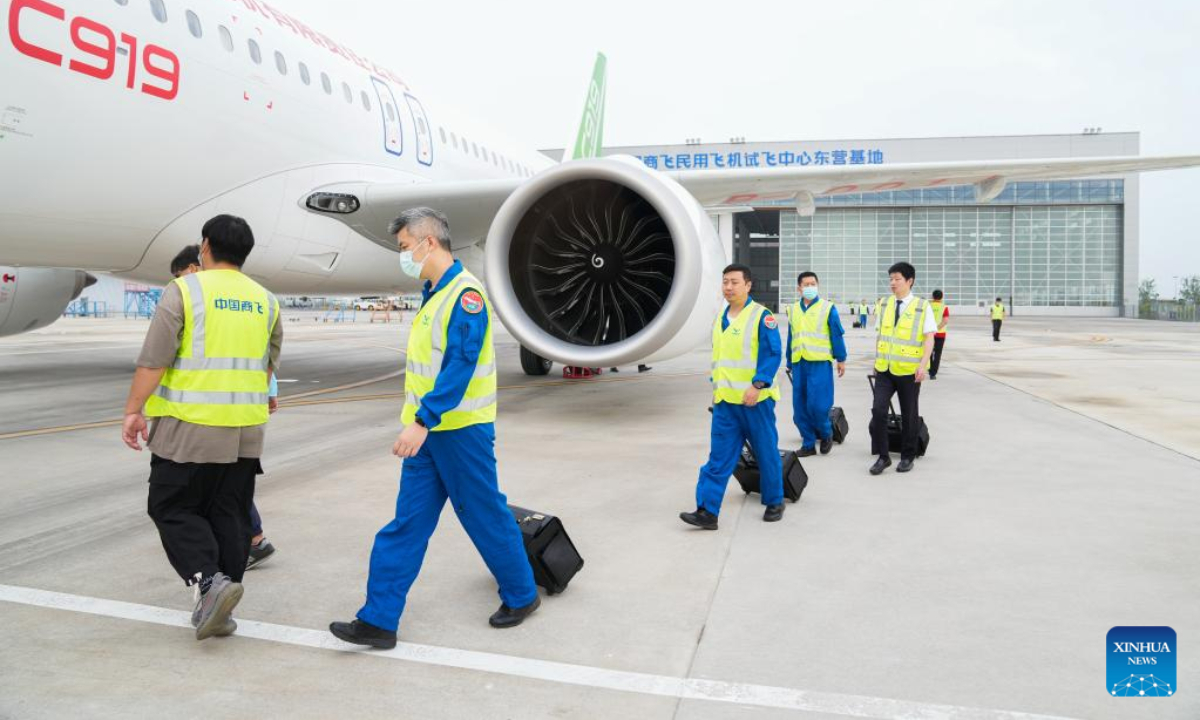 Crew members prepare to board the 7th C919 jet in Dongying City, east China's Shandong Province, July 21, 2022. The C919, China's first homegrown large jetliner, has obtained the type certificate, a milestone step on its journey to market operation. Photo:Xinhua