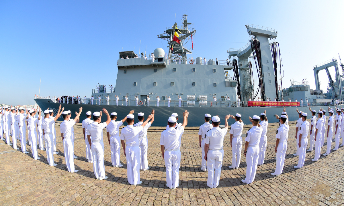 Naval servicemen assigned to the PLA Northern Theater Command wave goodbye to the crew on the comprehensive supply ship Kekexilihu (Hull No. 968) of the 42nd Chinese naval escort taskforce at a military port in Qingdao, east China's Shandong Province on September 21, 2022. (Photo by Liu Zaiyao)