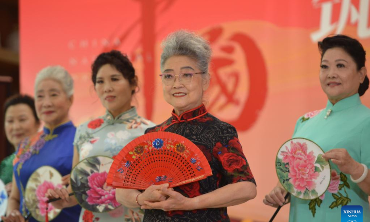 Han Xiangqiao (2nd R), 75, performs as a model during an activity in Xinhua District of Shijiazhuang, north China's Hebei Province, Oct. 3, 2022. Chinese elderly enjoy retired life as they indulge in their hobbies. (Photo by Yan Zhiguo/Xinhua)