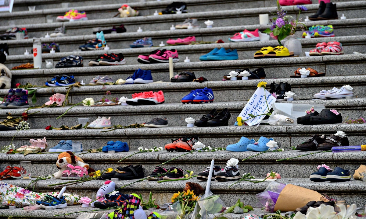 Children's shoes and toys are placed on the staircase outside Vancouver Art Gallery during a memorial event for the 215 children whose remains have been found buried at a former Kamloops residential school, in Vancouver, British Columbia, Canada, May 30, 2021. Photo:Xinhua