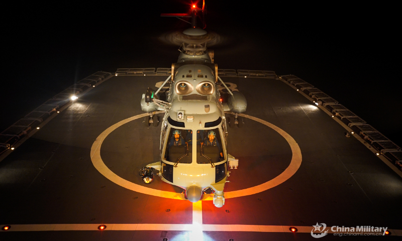 A ship-borne helicopter lands on the helipad of a warship during a round-the-clock training exercise on landing and taking off from the ship's helipad on September 7, 2022. (eng.chinamil.com.cn/Photo by Ma Yingming)