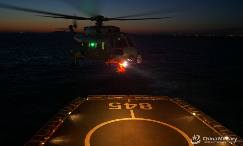 A ship-borne helicopter lands on the helipad of a warship during a round-the-clock training exercise on landing and taking off from the ship's helipad on September 7, 2022. (eng.chinamil.com.cn/Photo by Ma Yingming)