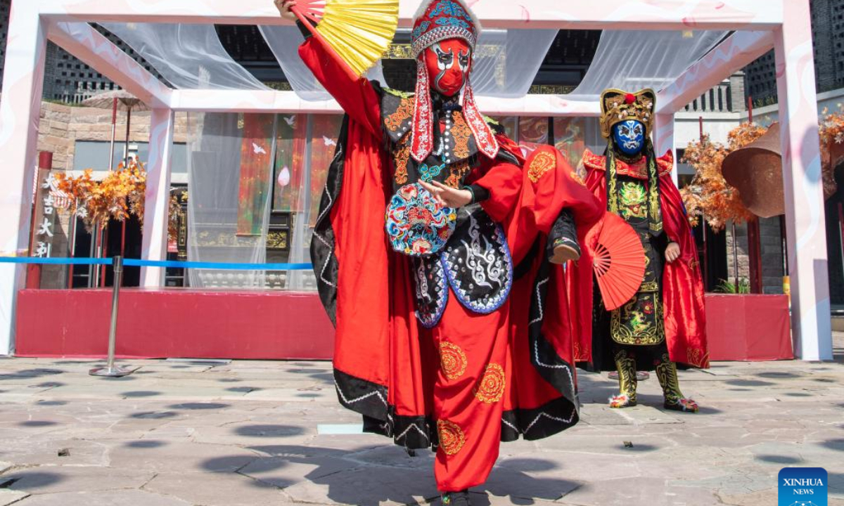 Artists perform Chuanju (Sichuan opera) in Ciqikou ancient town, southwest China's Chongqing Municipality, Oct. 2, 2022. During the National Day holiday, the scenic area Ciqikou has conducted various activities themed with traditional Chinese culture to attract tourists. (Xinhua/Tang Yi)