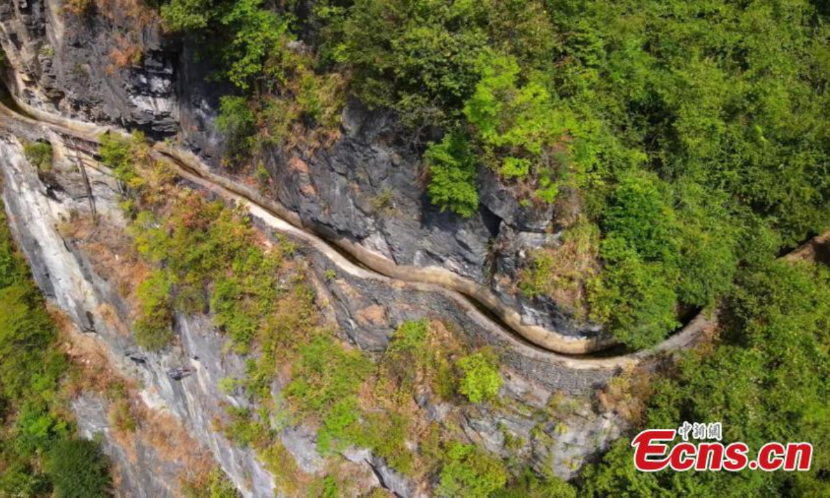 Photo shows an artificial canal built along a cliff in Huanghe town in Chongqing, Sept. 20, 2022. The 15-kilometer-long canal was constructed at an elevation of about 1,000 meters along the cliff in the 1970s. Photo: China News Service