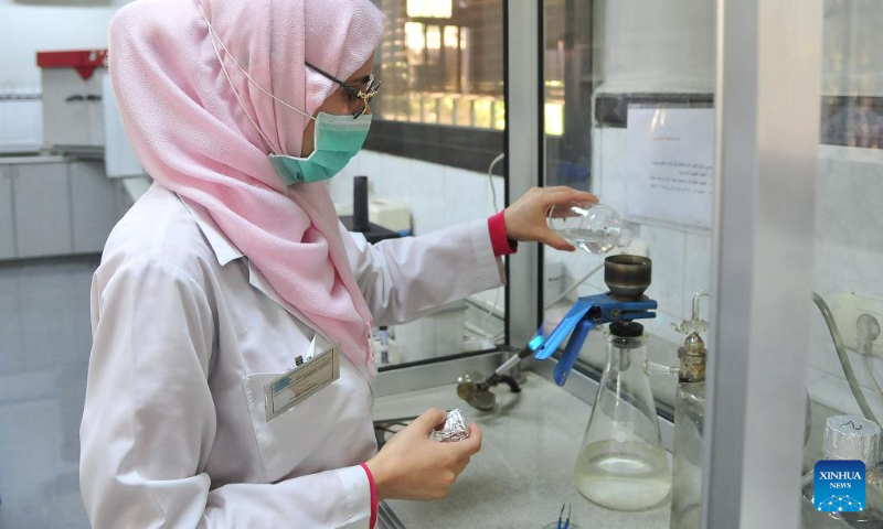 A staff member of Syrian health authority runs tests on water samples collected from different parts of capital Damascus, Syria, Sept. 25, 2022. (Photo by Ammar Safarjalani/Xinhua)