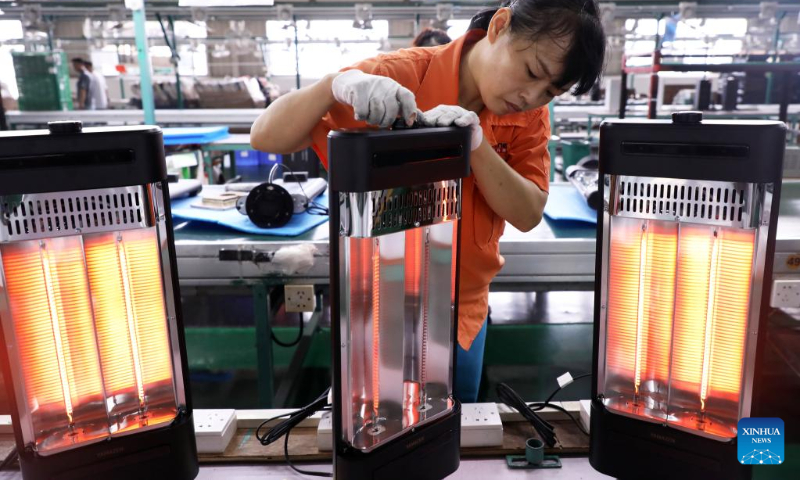A worker checks electric heaters at a company in Foshan, south China's Guangdong Province, Sept. 29, 2022. (Xinhua/Huang Guobao)