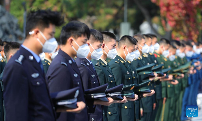 People pay a silent tribute during a commemorative event at the Chinese People's Volunteers (CPV) martyrs' cemetery in Shenyang, northeast China's Liaoning Province, Sept. 30, 2022. (Xinhua/Yang Qing)