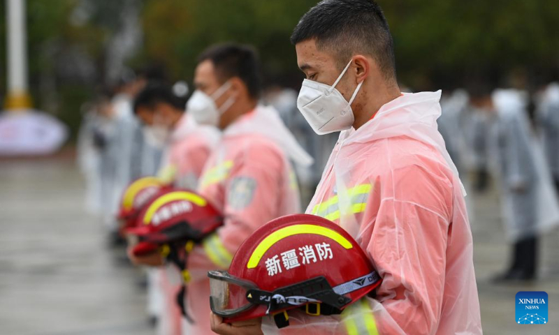 People pay a silent tribute to martyrs during a commemorative event at the People's Square in Urumqi, northwest China's Xinjiang Uygur Autonomous Region, Sept. 30, 2022. (Xinhua/Ding Lei)
