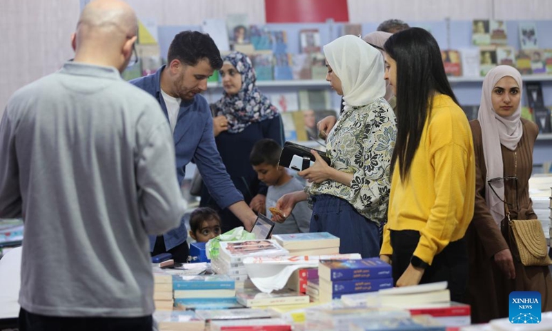 Palestinians visit the 12th edition of Palestine International Book Fair in Surda town, near the West Bank city of Ramallah, on Sept. 22, 2022.(Photo: Xinhua)