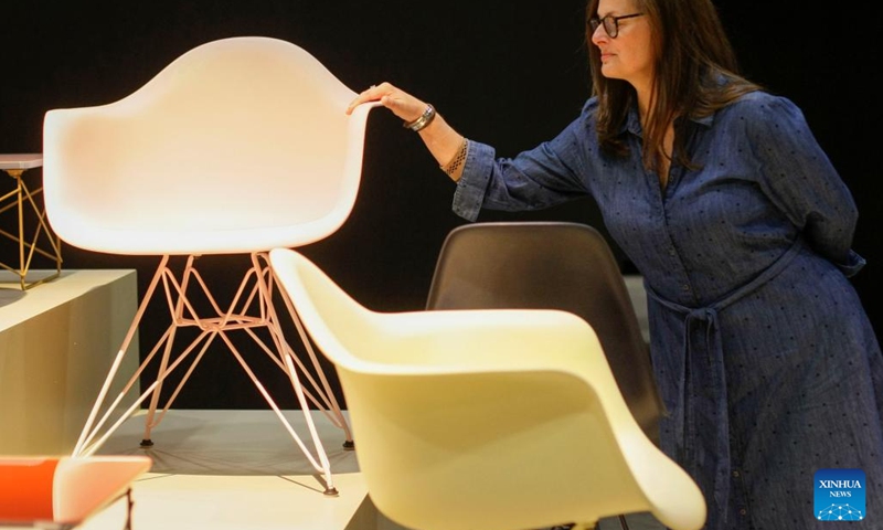 A woman looks at chairs at the Vancouver Interior Design Show in Vancouver, Canada, on Sept. 22, 2022. The show which is scheduled to run from Sept. 22 to 25 showcases the latest interior design ideas and products.(Photo: Xinhua)