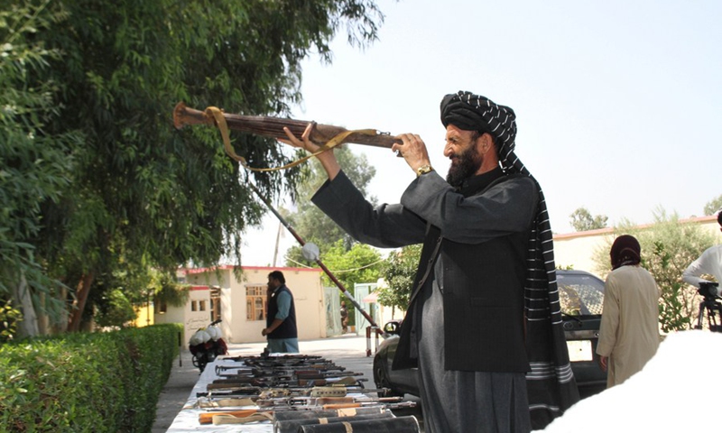 A man checks a weapon seized by Afghan law enforcement agencies in Jalalabad, capital city of Nangarhar province, Afghanistan, Sept. 21, 2022.(Photo: Xinhua)