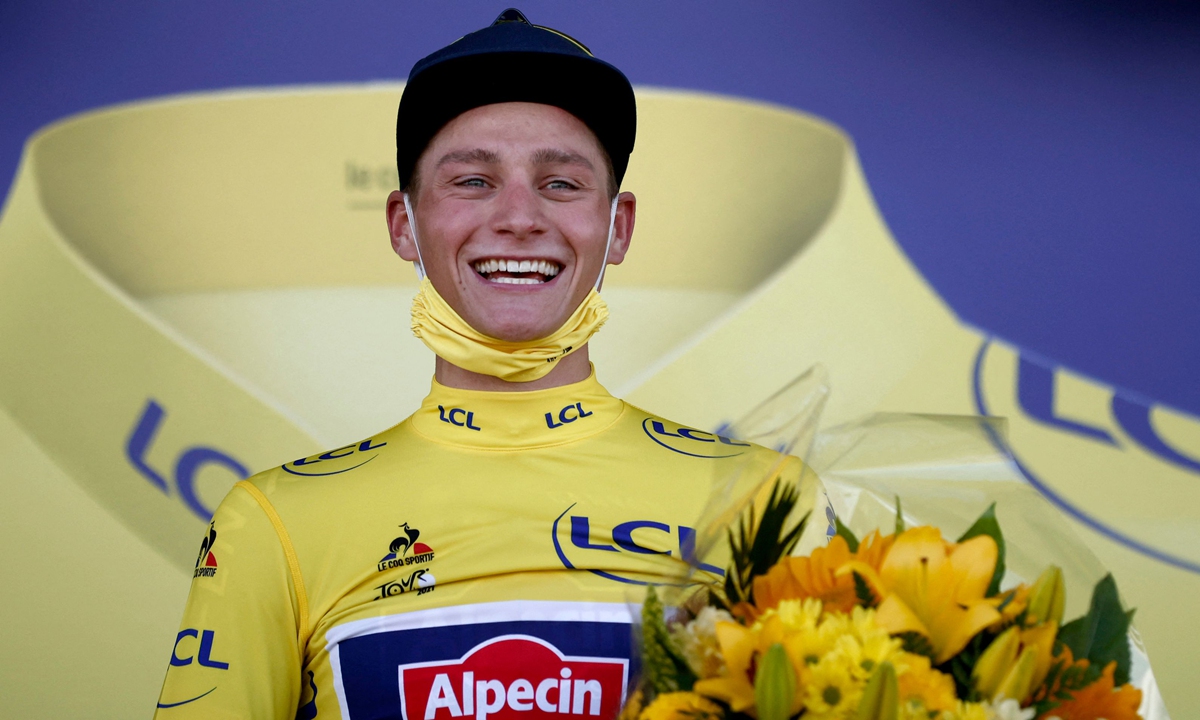 Team Alpecin Fenix' Mathieu van der Poel of Netherlands celebrates his overall leader's yellow jersey on the podium at the end of the 2nd stage of the 108th edition of the Tour de France cycling race, 183 km between Perros-Guirrec and Mur de Bretagne Guerledan, on June 27, 2021. Photo: VCG