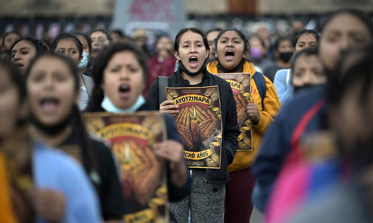 People take part in a march at the Zocalo square in Mexico City on September 26, 2022, to mark the eighth anniversary of the disappearance of 43 students. Photo: AFP