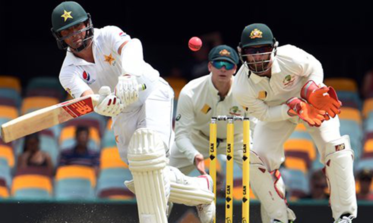 Pakistan's batsman Yasir Shah (left) plays a shot as Australia's wicketkeeper Matthew Wade looks on during the fifth day of the first day-night cricket Test match between Australia and Pakistan in Brisbane on Monday. Photo: AFP