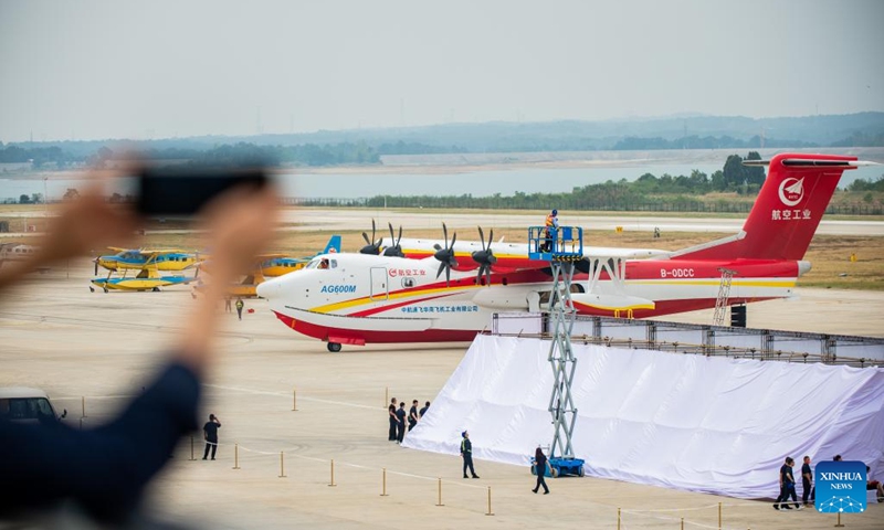 A visitor takes picture of an AG600M firefighting aircraft in Jingmen, central China's Hubei Province, Sept. 27, 2022. Codenamed Kunlong, the AG600 large amphibious aircraft family is seen as key aeronautical equipment for China's emergency-rescue system. It was developed by the Aviation Industry Corporation of China (AVIC), the country's leading plane-maker, to meet the needs of firefighting and marine-rescue missions, as well as other critical emergency-rescue operations.(Photo: Xinhua)